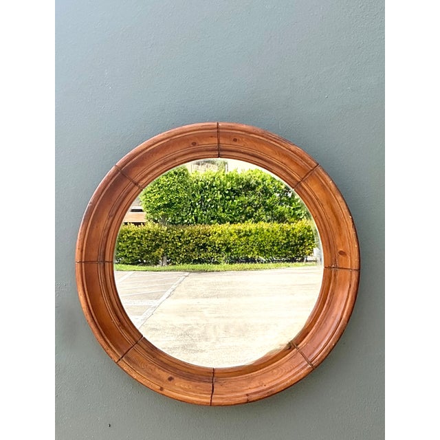 This vintage round wall mirror showcases timeless craftsmanship with its substantial solid wood frame and beautifully...