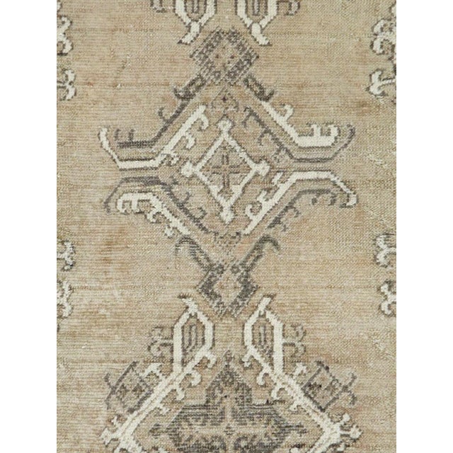 An antique Turkish Oushak carpet handmade during the early 20th century with an overall neutral and earth tone palette...