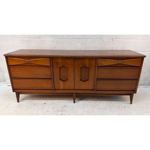 American furniture manufacturer Bassett crafted the "Danique" credenza out of cherry wood during the mid-century modern...