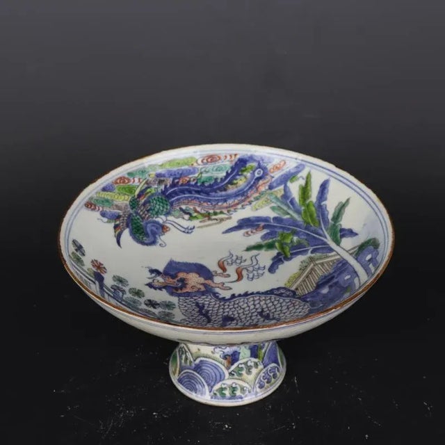W-20.7cm,H-cm This Blue and White Famille Verte Porcelain Stem Bowl features a beautifully painted Kylin Phoenix pattern,...