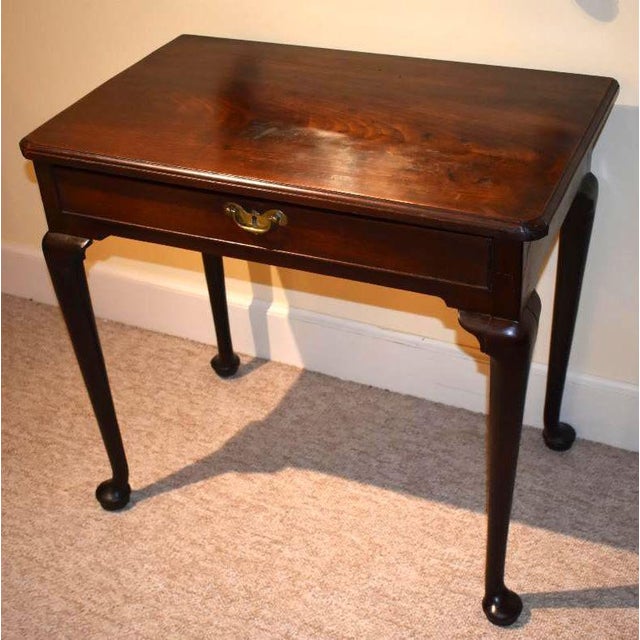 English walnut early Georgian or Queen Anne side table from the early 1700s . A lovely walnut slab with a molded edge...