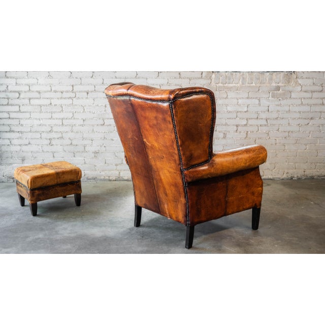 1970s Vintage Art Deco Distressed Cognac Leather Wingback Chair & Ottoman For Sale - Image 12 of 16