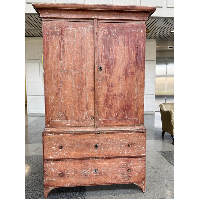 This Swedish folk or country cabinet case piece was hand-crafted in the 19th Century. It consists of two pieces: a cabinet...