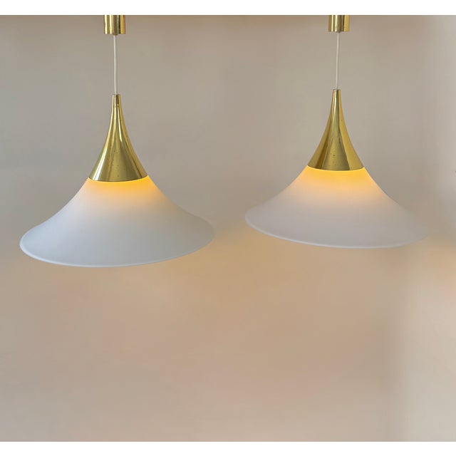 Pair of pendant lights by limburg, made of brass and opaline glass, produced in germany in the 1970s. warm, diffused...