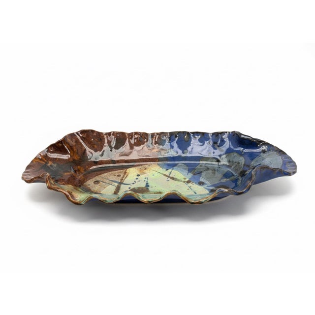 A striking signed and dated North Carolina studio pottery platter attributed to potter Bet Mangum, created in 2008. This...