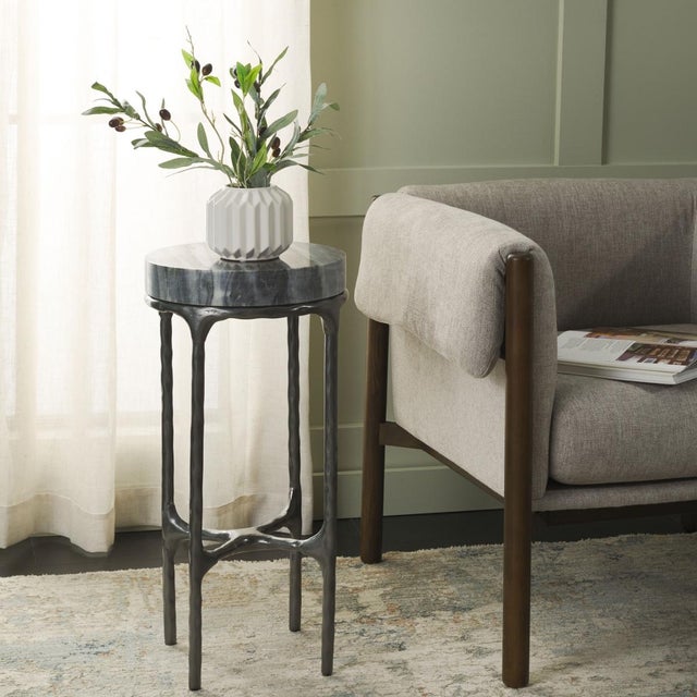 Introducing the Castiel hammered side table, a stunning addition to any living space. This piece features a unique grey...
