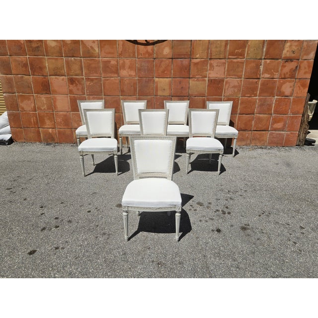 This is a set of 8 Swedish Gustavian style side chairs. They have been restored and repainted with milk paints "Oyster White"