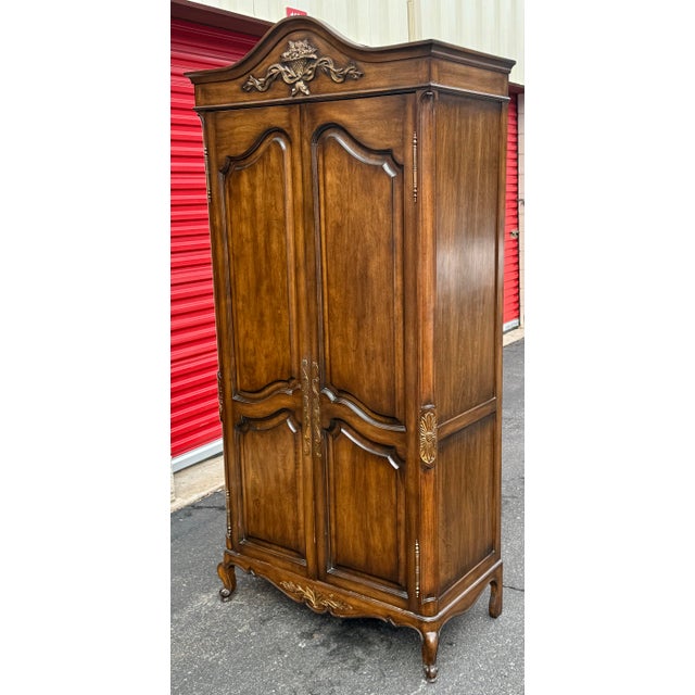 Beautiful french Country Louis XV style armoire, crafted from solid hardwood with a rich, warm finish. It features a...