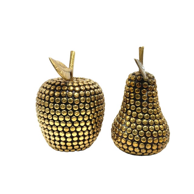 Elevate your interior with this stunning vintage brass apple and pear set. These textured brass ornaments offer a touch of...