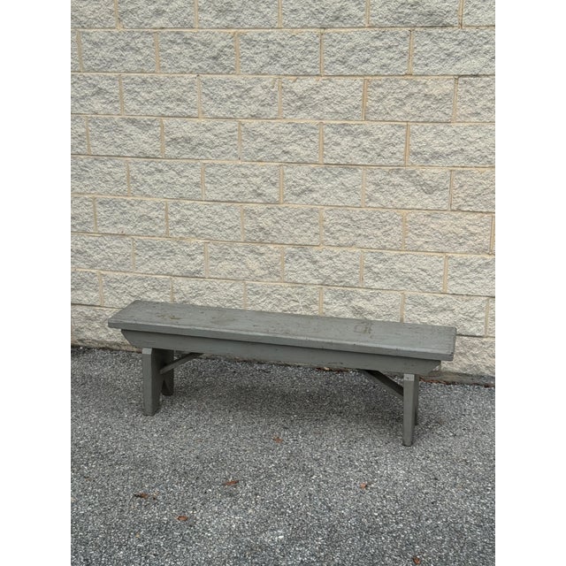 Long, narrow vintage wooden bench with a weathered gray painted finish, plank seat, and simple straight legs. Its...