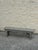 Long, narrow vintage wooden bench with a weathered gray painted finish, plank seat, and simple straight legs. Its...