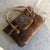 This vintage 1970s Italian top-handle handbag embodies the bohemian chic and artisanal spirit of the hippie era. Crafted...