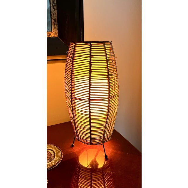 Infuse your space with warm Mid-Century Modern charm and bohemian style with this **Vintage MCM Rattan Boho Woven Tripod...