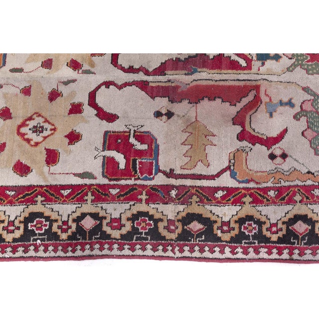 This striking Indian Agra runner is a carefully adjusted fragment of a larger antique carpet, meticulously repurposed to...