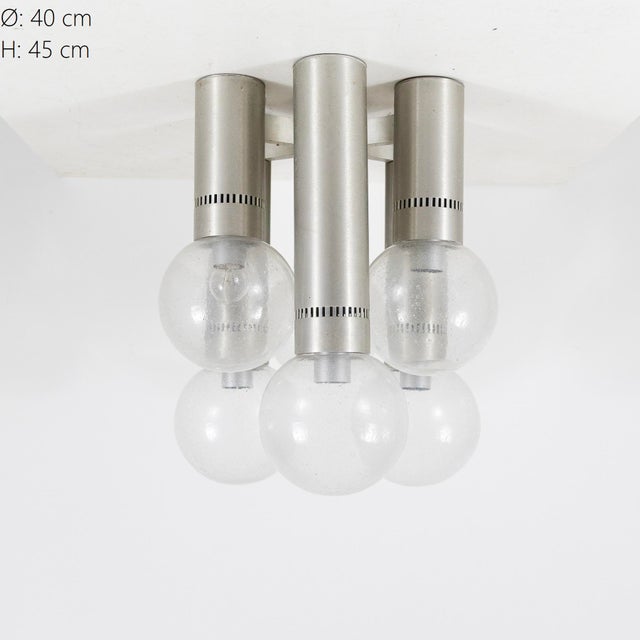 A ceiling lamp with a minimalist, geometric design, made in Italy in the 1970s. The structure is composed of six...