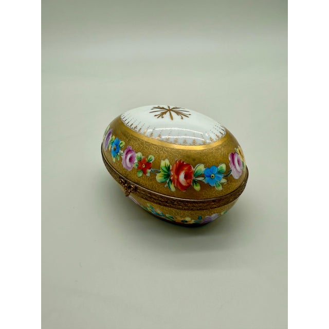 A richly decorated and collectible hand-painted porcelain trinket box by the famed Camille Le Tallec studio, Paris. This...