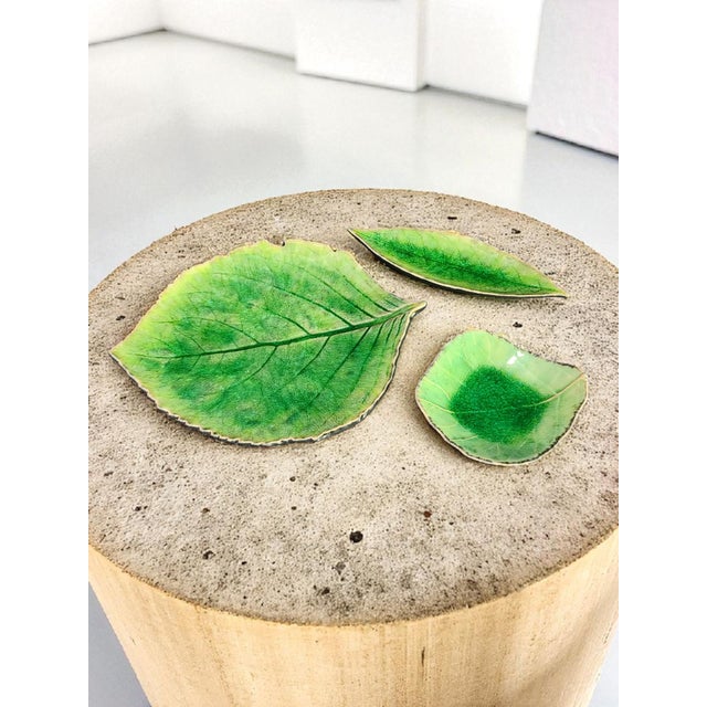 The Costa Nova Portugal Hand Painted Ceramic Set of 3 Green Leaf Dip Plates Bowls is a beautiful and unique addition to...