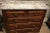 Elegant traditional antique mahogany five drawer chest of drawers, gray and white marble top, antique brass pulls, circa...