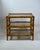 Elegant vintage three-tier side table crafted from bamboo with decorative rattan bindings and three lightly smoked glass...