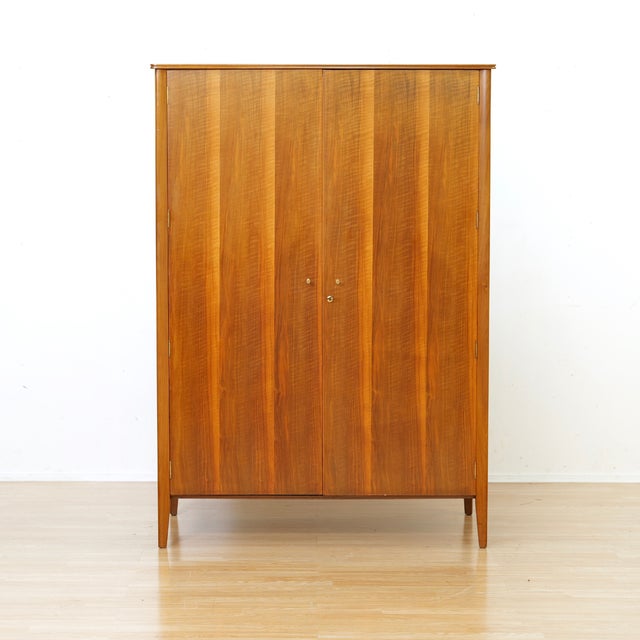 This vintage mid-century armoire was produced by A. Younger Ltd during the 1960s. Made from Australian walnut the two...