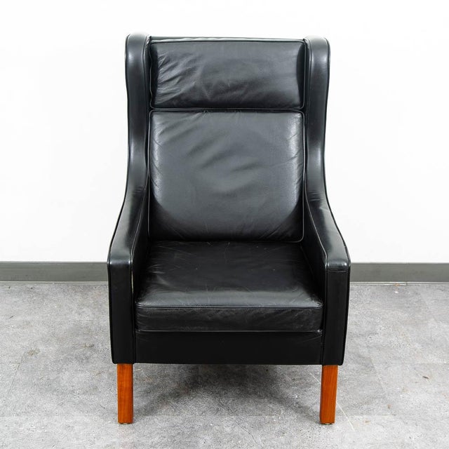 High quality black leather Danish modern wingback lounge chair. This piece was imported directly from Denmark in our...