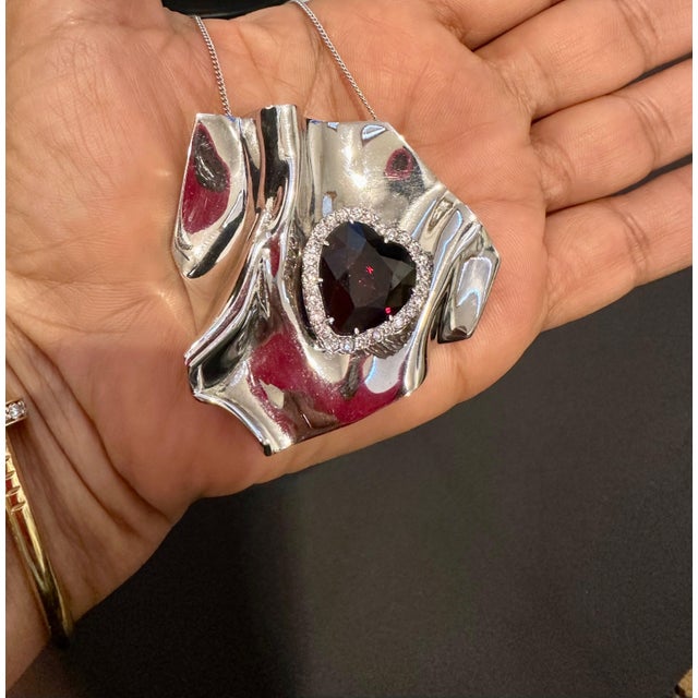 This Approximately 10 Ct Heart Shape Garnet & 1.5 Ct Diamond Pendant Necklace/pin in 14 Kt White Gold is a true...