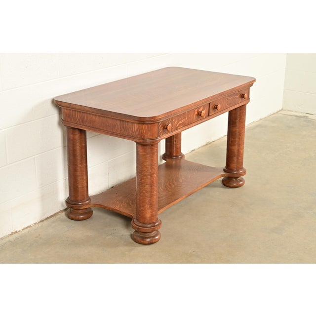 A gorgeous antique Late Victorian, Arts & Crafts, or American Empire tiger oak writing desk or library table In the manner...