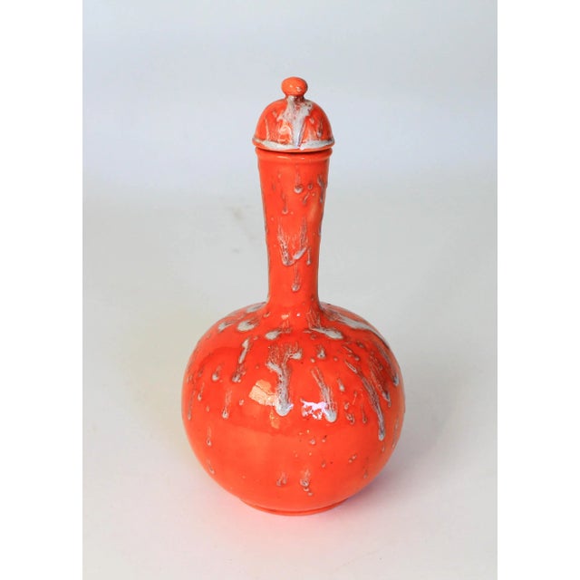 Mid-century modern orange and white studio art drip glaze pottery lidded bottle vase. No makers mark. Minor age wear. No...