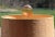 Single lamp finial crafted from a large glass bubble in translucent peach topping a golden brass swivel base....