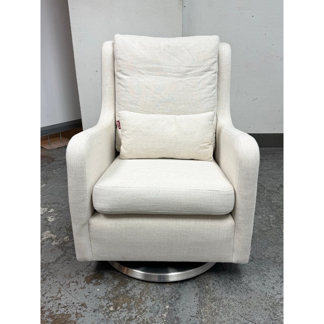 Design Plus Gallery presents a Milo Swivel Glider Chair from Monte for Crate & Barrel. This modern upholstered swivel...
