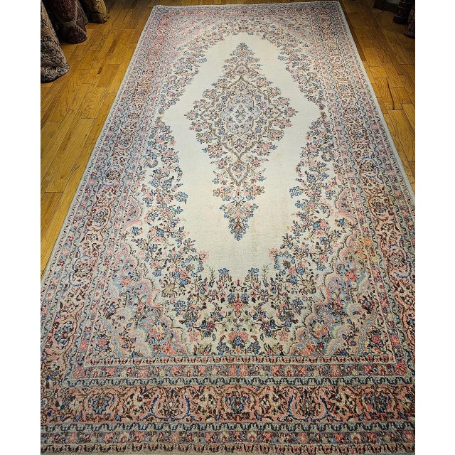 This vintage oversized Persian Qazvin rug is a stunning example of fine craftsmanship and timeless design, inspired by the...