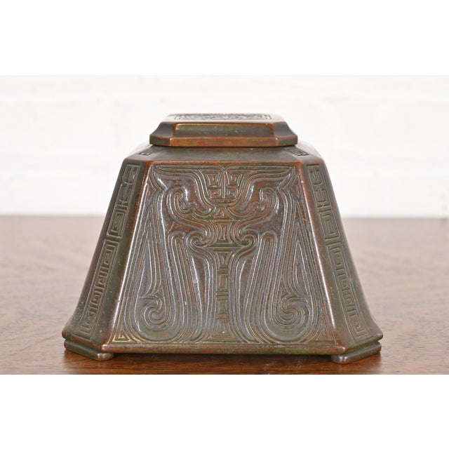 A gorgeous Arts & Crafts period "Chinese" pattern bronze inkwell By Tiffany Studios (signed to the underside) New York,...