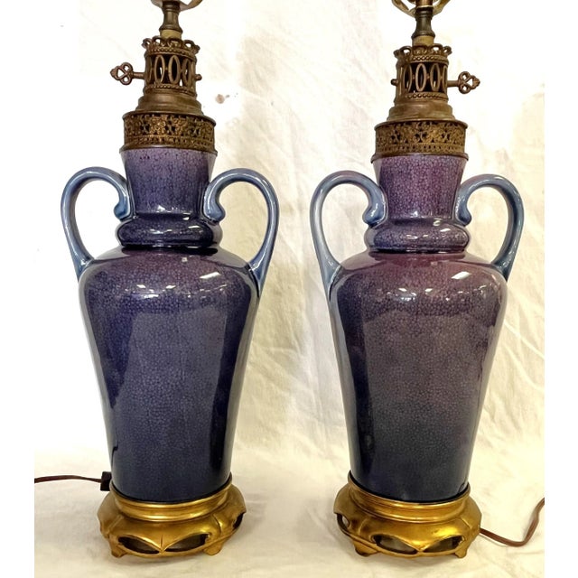 Pretty pair of vintage Amphora shaped handled vases made into lamps. The ceramic vases have a floral pattern background...