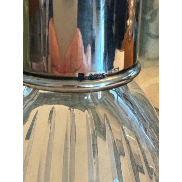 Beautiful tall decanter with a silver stem. There are stamps with 925, a shield insignia, and other small marks. Might be...