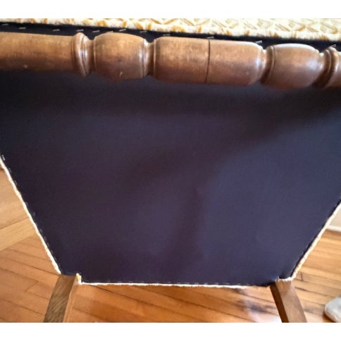 Gorgeous vintage carved arm chair. Features a classic shield-back silhouette, beautifully detailed wood carving along the...
