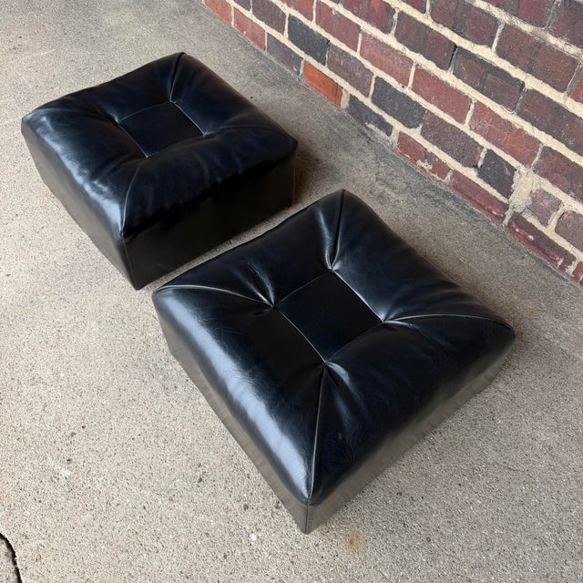 Pair of square ottomans on castors make great stools to sit in around a coffee table for hanging out with friends