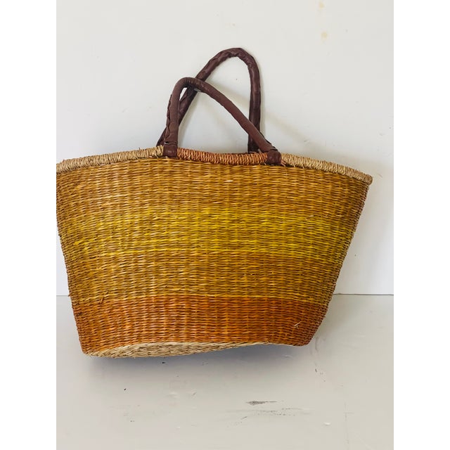 Antique Woven market basket with leather handles.