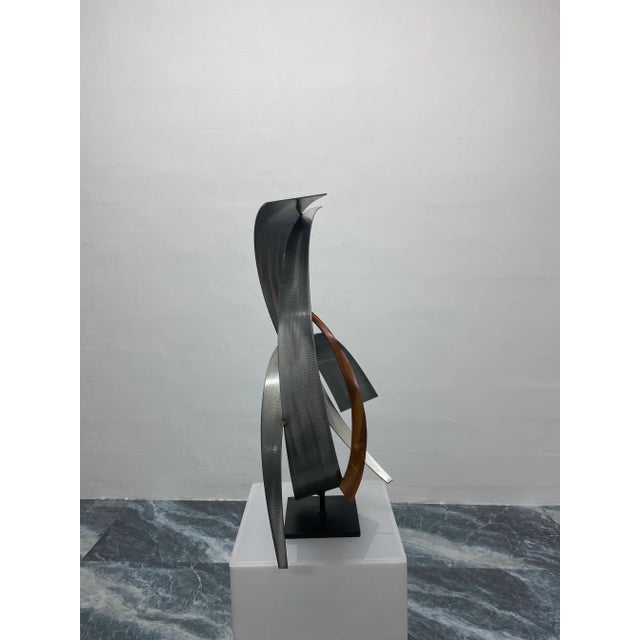 Brushed steel and copper sculpture on black steel base by Curtis Jere Artisan House, 2009. Signed.