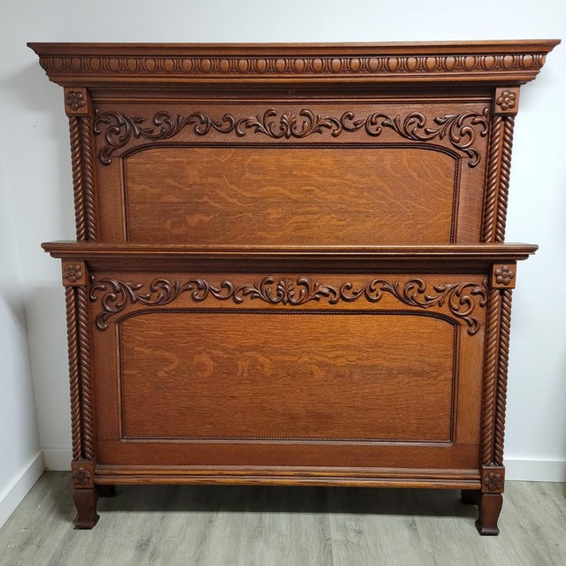 This antique American bed is crafted in richly figured quarter-sawn tiger oak, dating to the late Victorian–early...