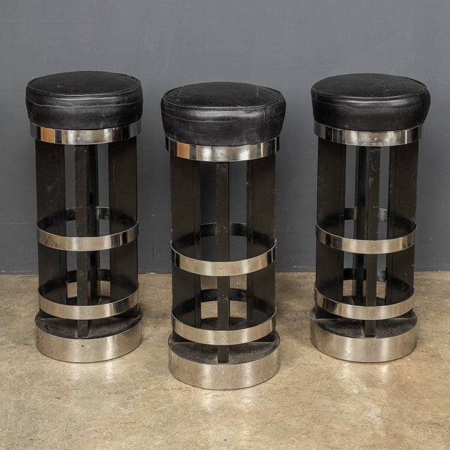 A mid 20th Century set of three leather and chrome swivel top bar stools straight from an iconic American diner. Height:...