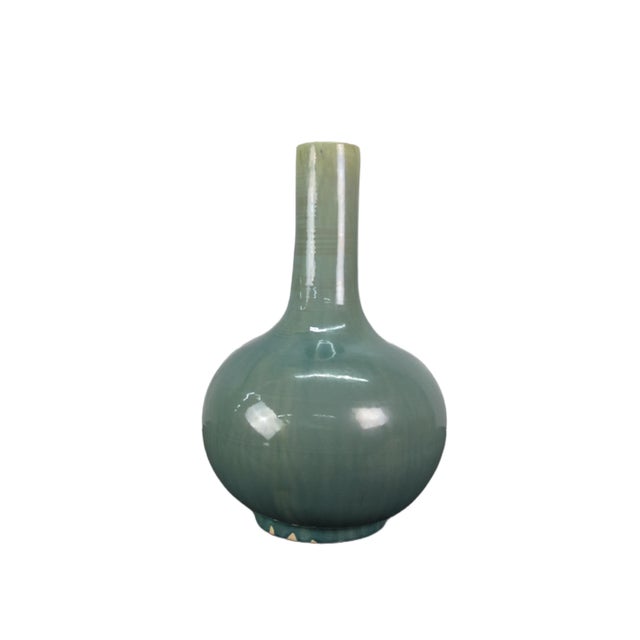The elegant turquoise long neck vase is handmade and glazed. Each has its own unique glazed line and characteristics. Item...