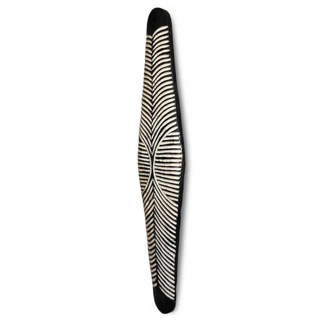 Vintage elongated black and antiqued white carved wood Zulu shield. Traditional South African Zulu shields date back to...