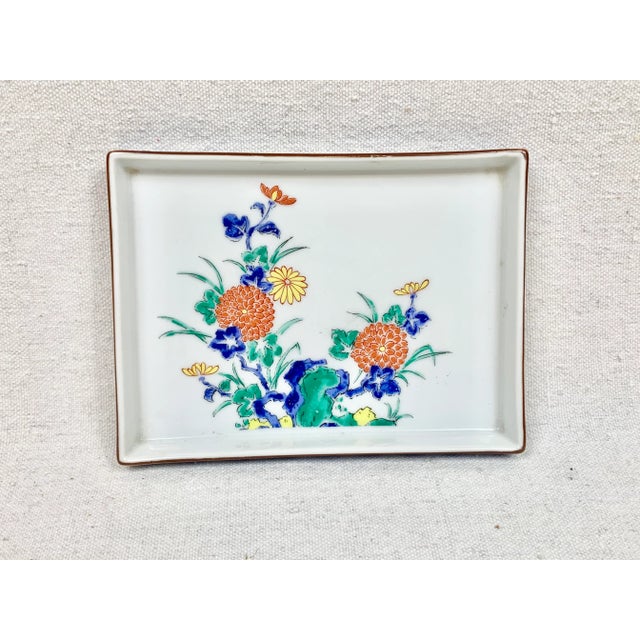 Beautiful vintage catchall. Ceramic. Features a floral design in the middle with a wonderful blue and white border on the...