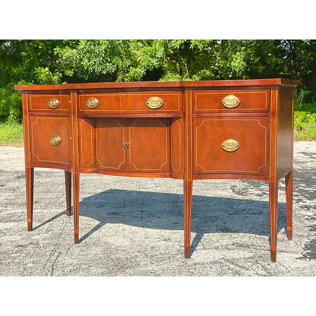 A fabulous vintage Regency Mahogany sideboard. Made by the iconic Baker Furniture group and tagged inside the drawer. A...