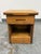 Design Plus Gallery presents a Rustic Pine Wood Nightstand. The single drawer nightstand offers solid wood construction...