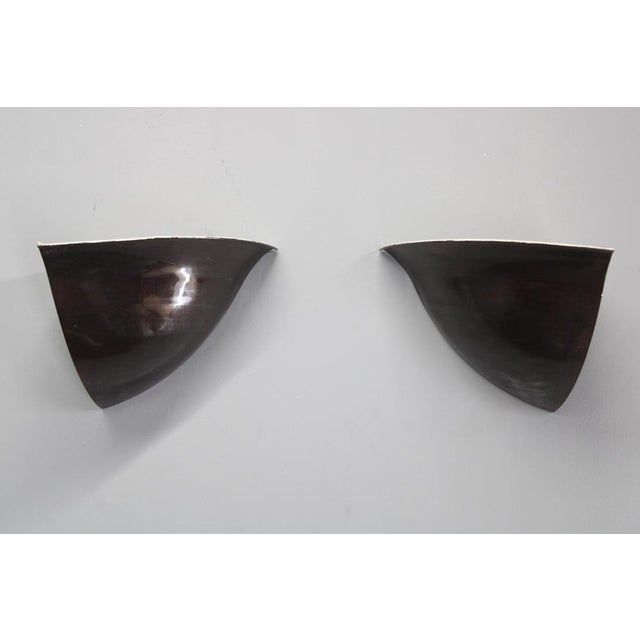 An exceptional pair of art deco corner wall sconces made of patinated copper, produced in czechoslovakia in the 1930s....