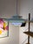 This slatted lamp from Formlight in Denmark skillfully plays with form and color: Five layered slats combine to create a...