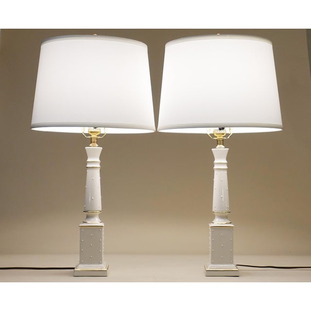 An impressive and visually stunning matched pair of Neoclassic Hollywood Regency Modern Column form fine Porcelain & Brass...