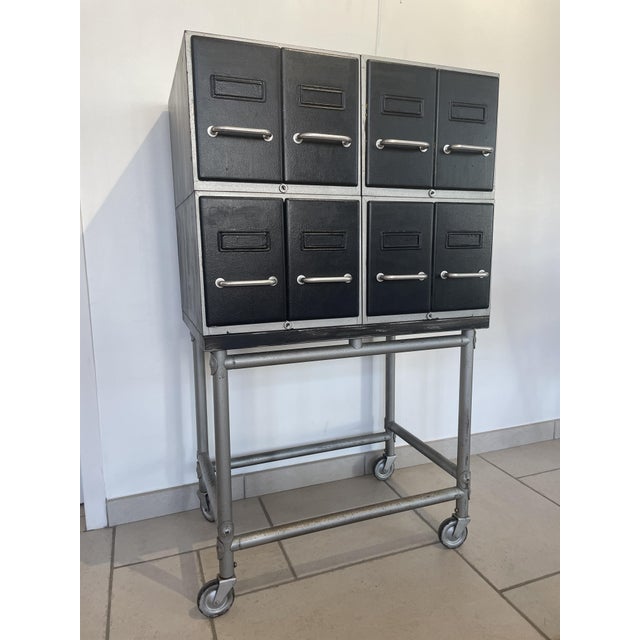 This metal filing cabinet features eight drawers arranged in four interlocking sections and is mobile thanks to its...