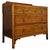 A charming early 20th-century English chest of drawers, well crafted from golden oak and distinguished by its warm...
